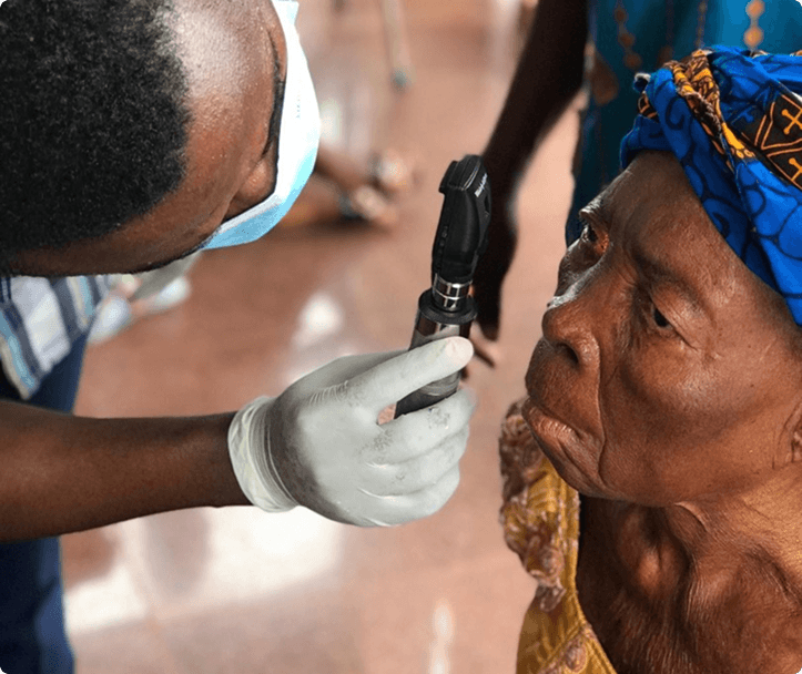 Doctor screening an elderly patient during the NFH cataract mission