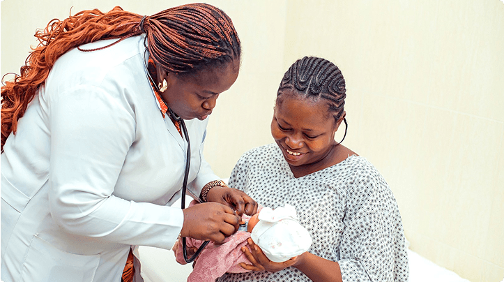 Health worker administering a vaccine to a baby with their mother present