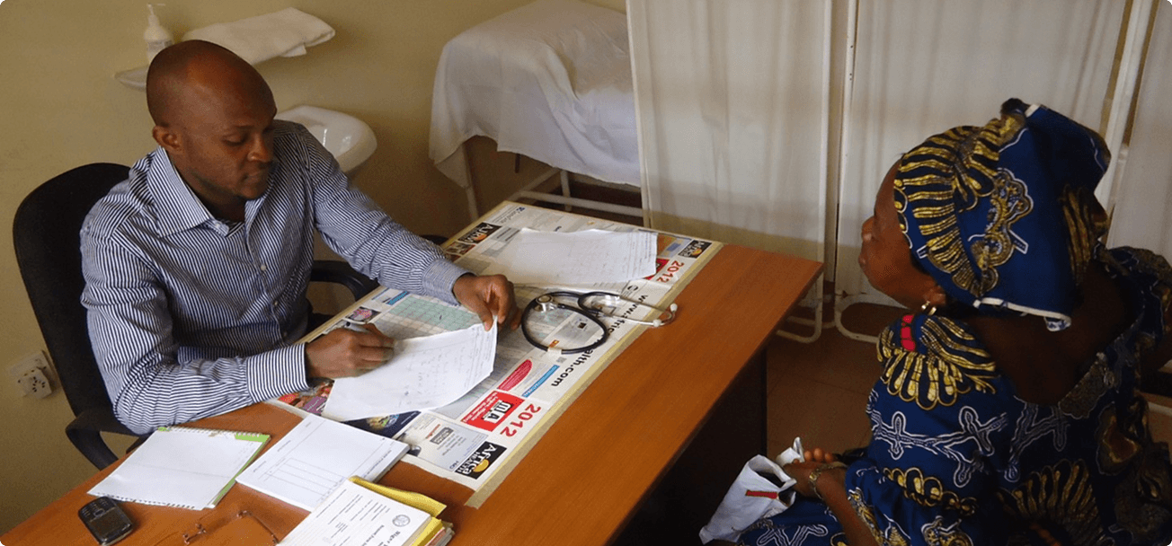 Physician consulting with a patient at the Iwollo Rural Health Centre